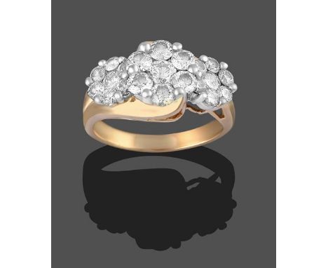 A Diamond Triple Cluster Ring, three graduated old cut diamonds within borders of smaller old cut diamonds, in white claw set