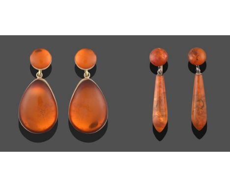 A Pair of Amber Drop Earrings, a circular cabochon amber suspends a pear shaped cabochon amber, in yellow rubbed over setting