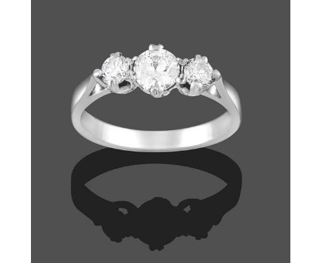 A Diamond Three Stone Ring, the graduated round brilliant cut diamonds in white claw settings, on a tapered shoulder plain po