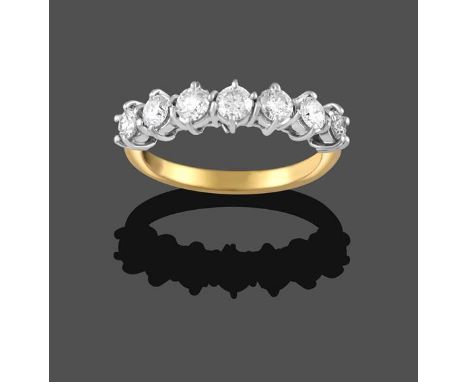 An 18 Carat Gold Diamond Seven Stone Ring, the round brilliant cut diamonds in white claw settings, on a yellow tapered shoul