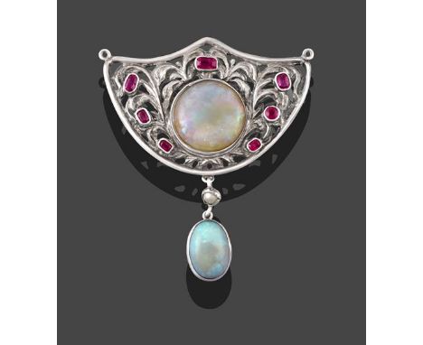 An Arts &amp; Crafts Style Opal and Ruby Brooch, the shield motif set centrally with a circular cabochon opal with vari-cut r