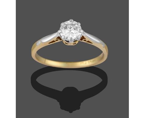 A Diamond Solitaire Ring, the round brilliant cut diamond in a white claw setting, to a yellow tapered shoulder plain polishe