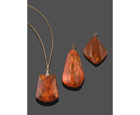An Amber Pendant on A 9 Carat Gold Chain, the cushion shaped amber, on a yellow trace link chain, pendant measures 4.0cm by 3