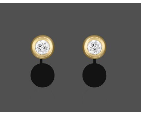 A Pair of 18 Carat Gold Diamond Solitaire Earrings, the round brilliant cut diamonds in yellow rubbed over settings, total es