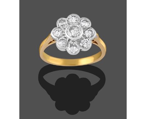 An 18 Carat Gold Diamond Cluster Ring, the central round brilliant cut diamond within a border of smaller round brilliant cut