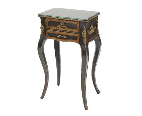 A French inlaid and ebonised lamp table, late 19th century, with ormolu mounts and two frieze drawers on boldly scrolled legs