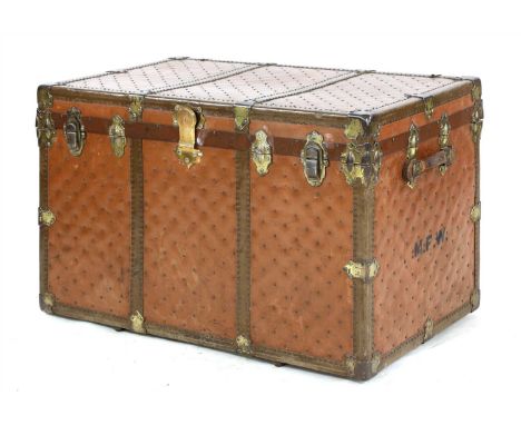 A large leather and studded travelling trunk, c.1920, set with brass hasps, the interior with a lift-out tray and labelled wi