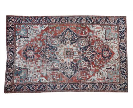 An Heriz Serapi carpet, 20th century, the central star-shaped cartouche with stylised foliage on a red ground, 390 x 320cm