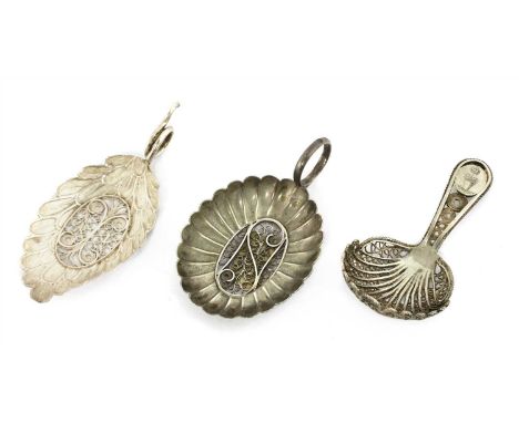 A George III silver caddy spoon , Samuel Pemberton, Birmingham 1805, together with two further silver filigree caddy spoons ,