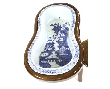 A Chippendale period mahogany bidet and cover, of waisted shape with a Chinese blue and white basin on square tapering legs, 