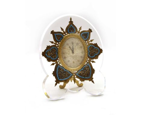 A French strut clock, early 20th century, with a glass body, possibly by Baccarat or St Louis, enclosing a gilt brass dial wi