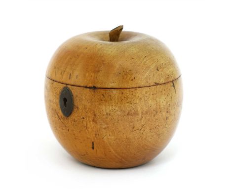 A fruitwood tea caddy, 19th century, in the form of an apple with an hinged lid and oval iron escutcheon, 12cm high