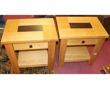 A pair of contemporary light oak single drawer two-tier lamp tables, width 58cm