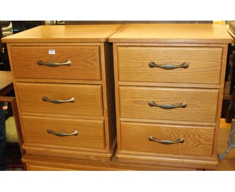 A pair of contemporary light oak three drawer bedside chests, width 53cm