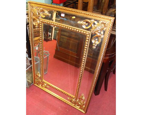 A large contemporary floral gilt decorated bevelled rectangular wall mirror, 121 x 89cm