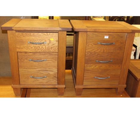 A pair of contemporary light oak three drawer bedside chests, each width 55.5cm