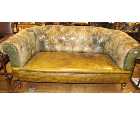 A Victorian green buttoned upholstered and brass studded two seater Chesterfield, raised on turned tapering forelegs, width 1