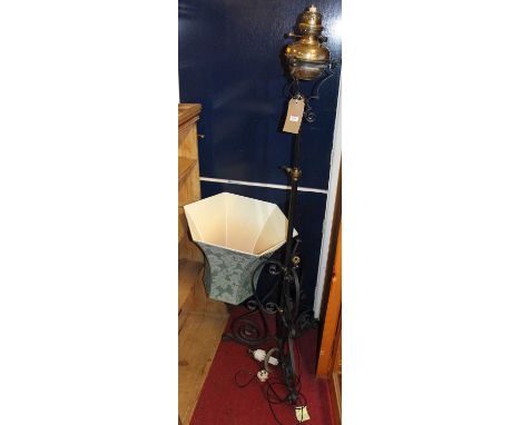An early 20th century black painted wrought iron and brass telescopic standard lamp (formerly a paraffin lamp)