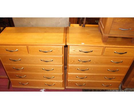 A pair of contemporary light oak chests of two short over four long drawers, each width 100cm