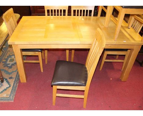 A contemporary light oak dining suite comprising; extending dining table having pull-out action and single extra drop-in leaf