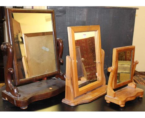 A Victorian mahogany swing toilet mirror, together with a further pine swing dressing mirror, and one other smaller mahogany 