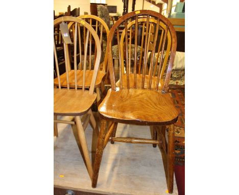 An Ercol light elm stickback kitchen chair, together with three further various elm and beech stickback kitchen chairs (4)Con