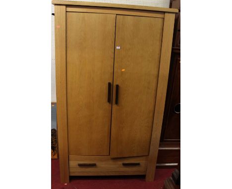 A contemporary light oak double door wardrobe, having single long lower drawer, width 115cm