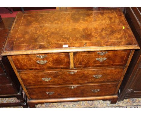 A William &amp; Mary style figured walnut and further strung chest of two short over two long drawers, raised on bracket supp