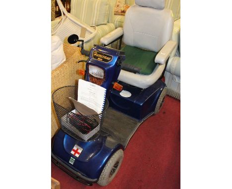 A Hurricane Pride battery powered mobility scooter, with cover, charger, owner's manual, and key