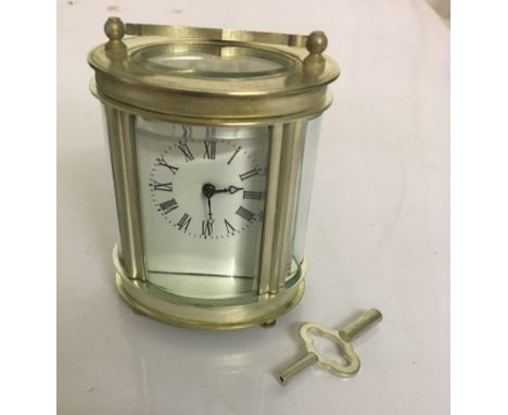 A miniature brass carriage clock