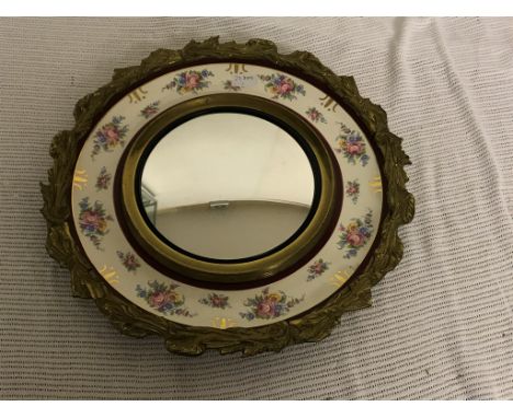 A ceramic and gilt wall mirror
