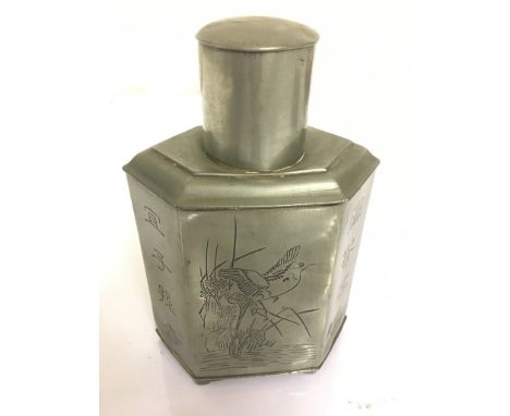 A Japanese engraved pewter tea caddy with character marks