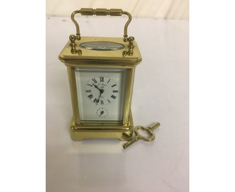 A miniature brass carriage clock