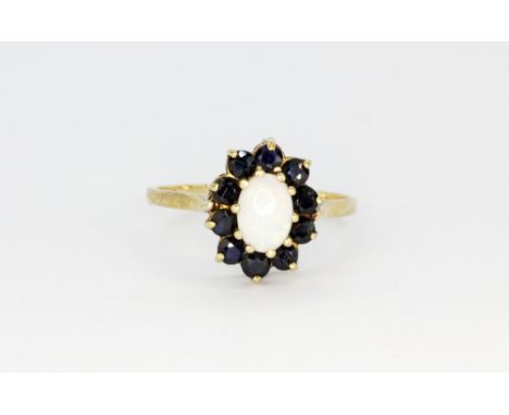 A 9ct yellow gold opal and sapphire set cluster ring, (O.5).