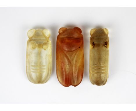 A group of three carved rock crystal insect netsuke, largest 6.5cm.