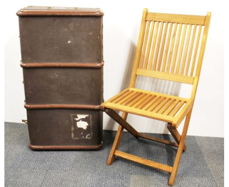 A vintage cabin trunk and folding chair.