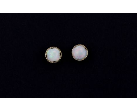 A pair of 9ct yellow gold opal set stud earrings, Dia. 0.6cm.