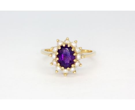 A 14ct yellow gold cluster ring set with an oval cut amethyst surrounded by pearls, (M).