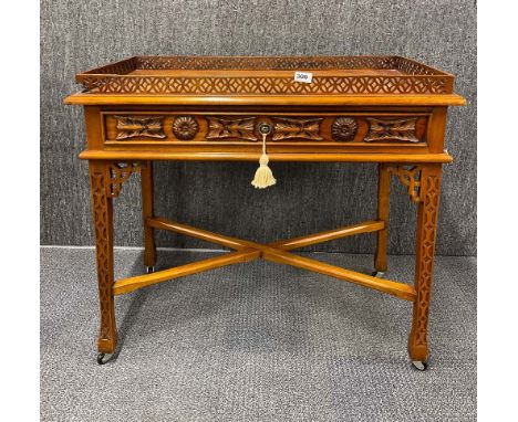 A reproduction carved light mahogany gallery silver table, size 90cm x 49cm x 78cm. A/F to gallery.