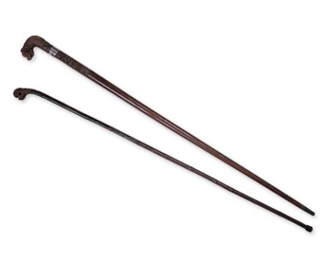 AN ANGLO-INDIAN WALKING STICK AND ONE OTHER
Anglo-Indian carved in hardwood with lion pommel, inset white bead eyes (one miss
