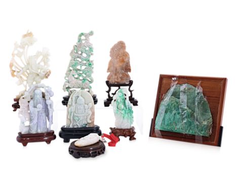 A GROUP OF EIGHT JADE ITEMS WITH WOOD STANDS
One specimen, six carved as sages and sages with carp and deer, one depicting a 