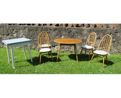 An Ercol style kitchen table and four stick back chairs, together with a kitchen extending table