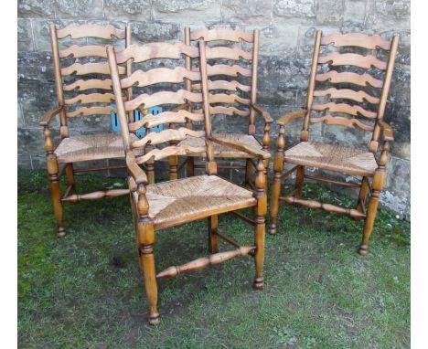 A set of four ladder back armchairs, with rush seats