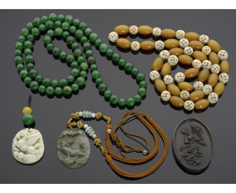 TWO CHINESE CARVED JADE PENDANTS AND A HORN PENDANT  4.5-7cm h, and two strings of beads (5)++Several of the beads damaged, h