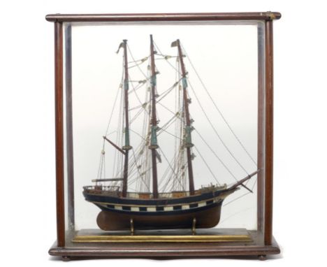 A VICTORIAN MAHOGANY AND PAINTED WOOD MODEL SHIP, 19TH C   with three masts, rigging and deck detail, the cloth pennant inscr