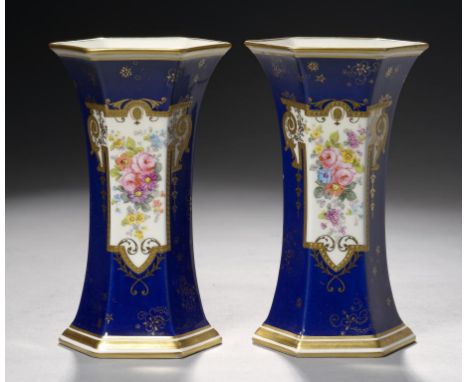 A PAIR OF ROYAL CROWN DERBY COBALT CROWN HEXAGONAL VASES, 1939  painted with a lappet shaped panel of flowers in raised gilt 