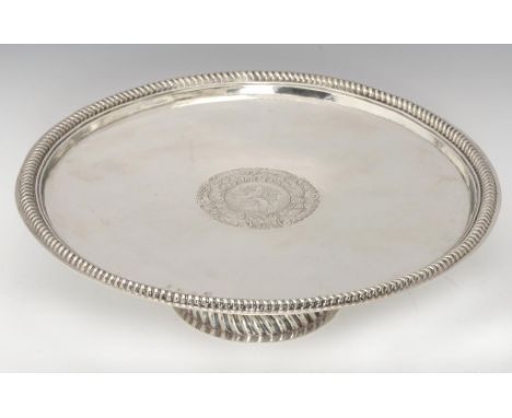 A QUEEN ANNE SILVER SALVER with gadrooned rim and domed foot, engraved with contemporary armorials, the underside inscribed W