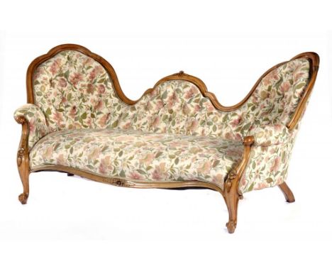 A VICTORIAN WALNUT SOFA, C1860  of serpentine, twin spoon back form, carved with leafage and flower pendants, 92cm h++Good co