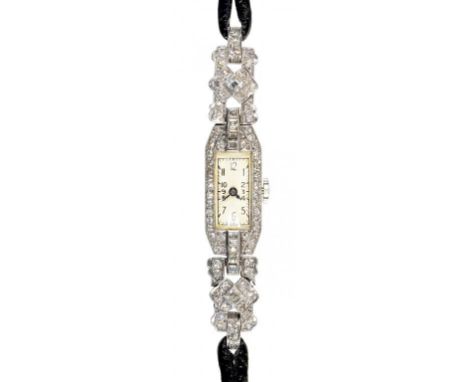 AN ART DECO DIAMOND COCKTAIL WATCH  in platinum with hinged lugs on corded leather strap, 57mm including lugs++In working ord