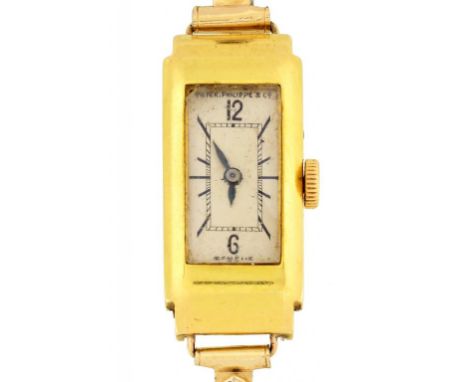 A PATEK PHILIPPE 18CT GOLD OBLONG LADY'S WRISTWATCH No 817426, in plain case with curved shoulders, 14 x 31mm, on expanding b